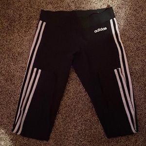 Black leggings with white stripes all the way down the side